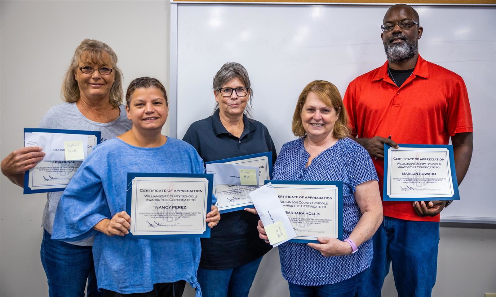 Five cafeteria managers, four women and one man, hold up certificates